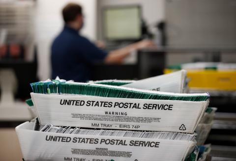 USPS mail trucks at a postal facility